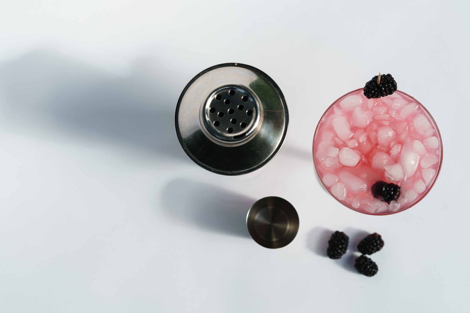 A stainless steel cocktail shaker on a bright kitchen counter