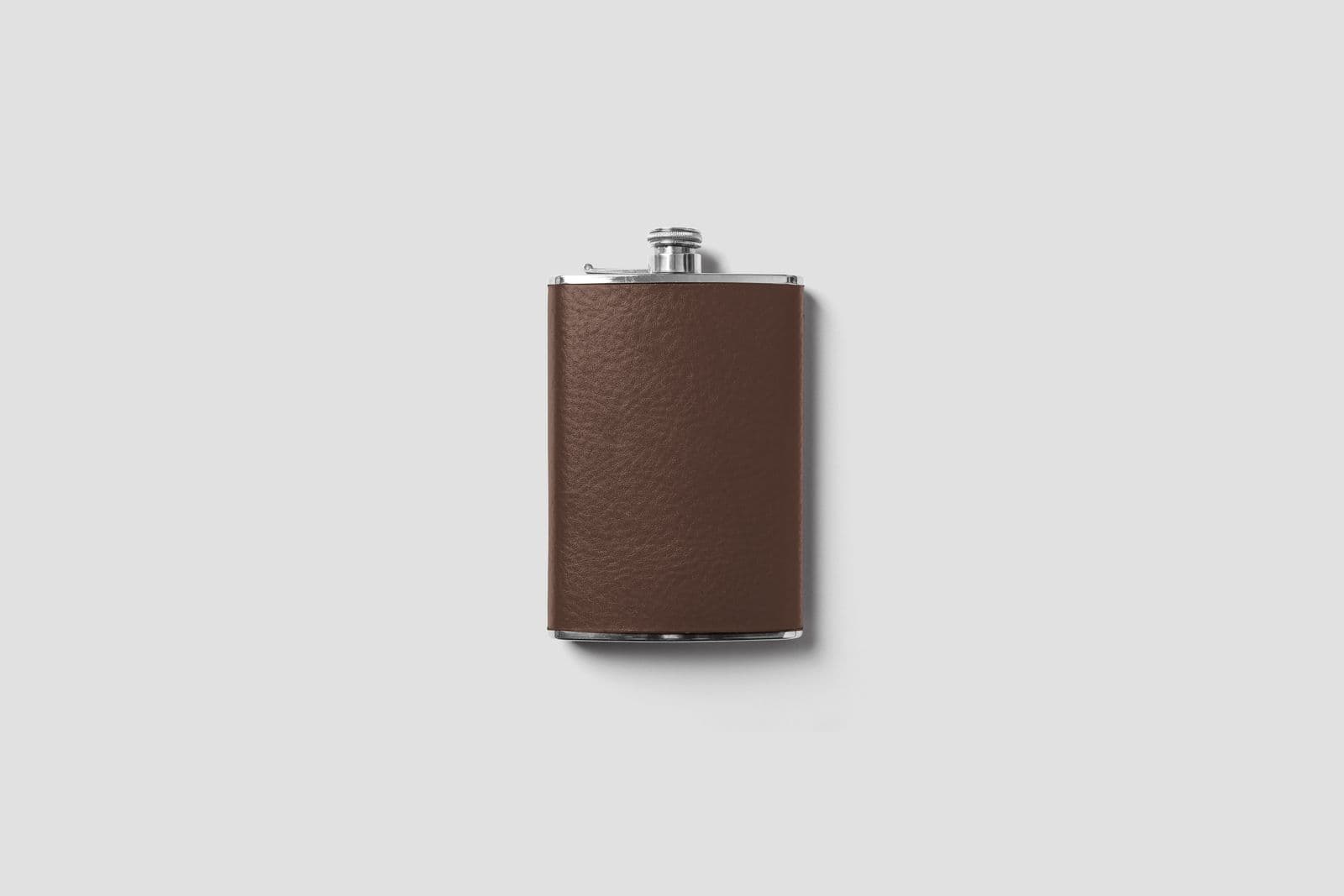 A leather-wrapped hip flask against a white background