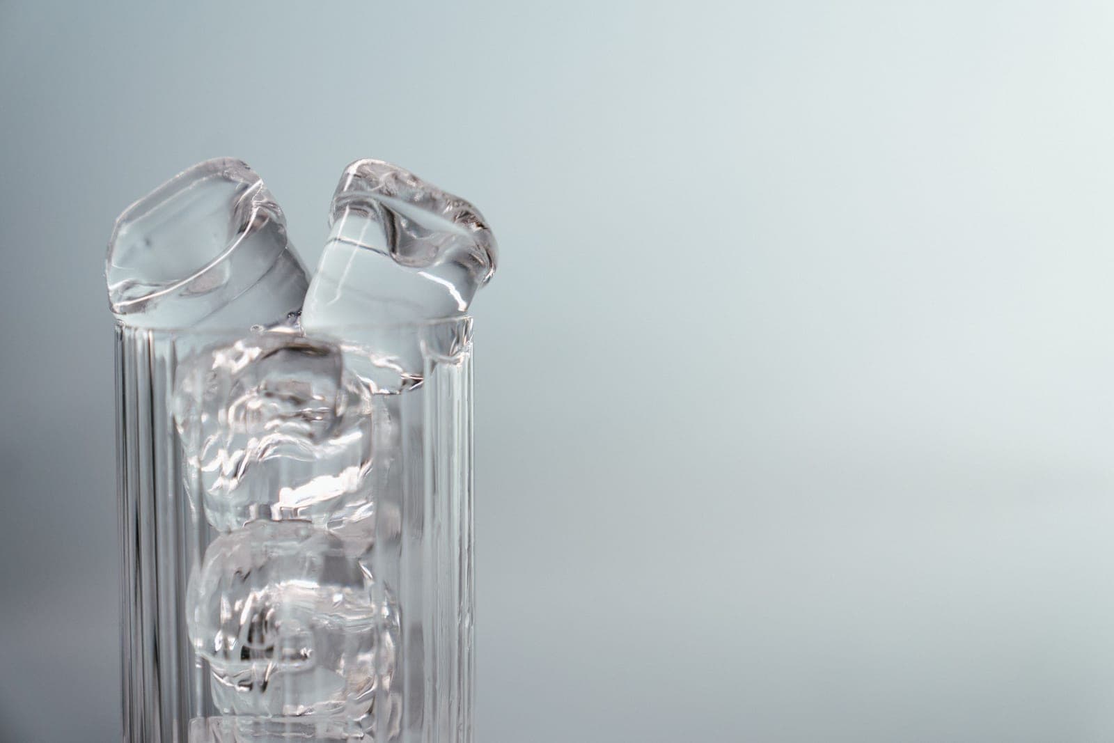 Tall highball glasses with ice in bright light