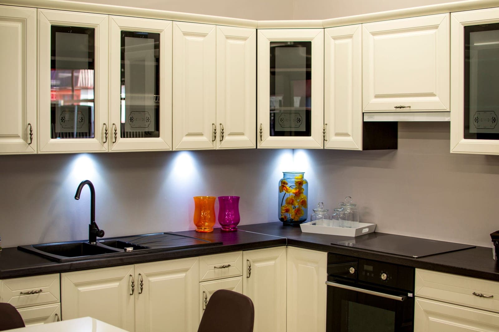 Glasses in an open kitchen cabinet in bright light