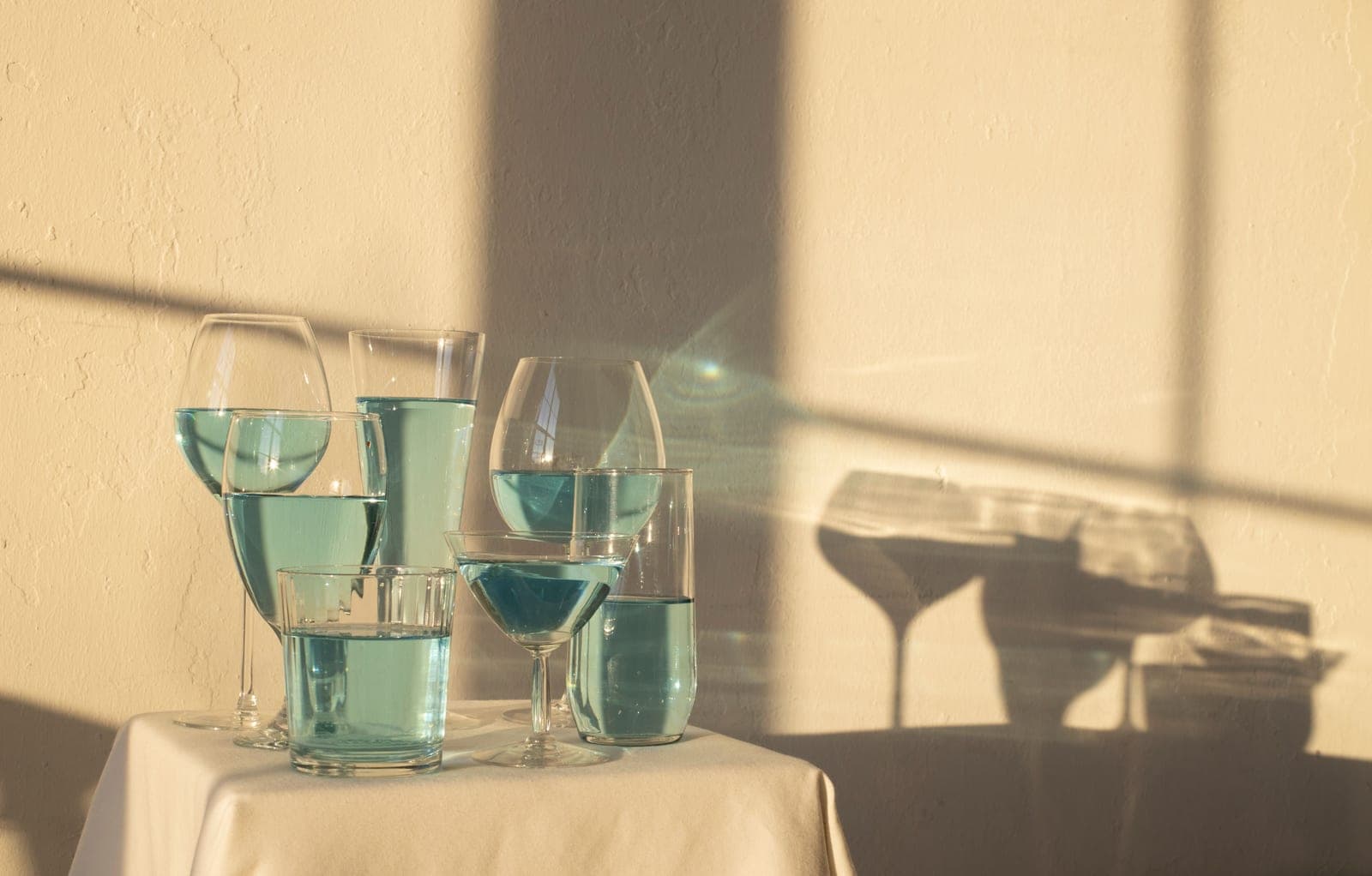 Different glassware shapes arranged on a bright table